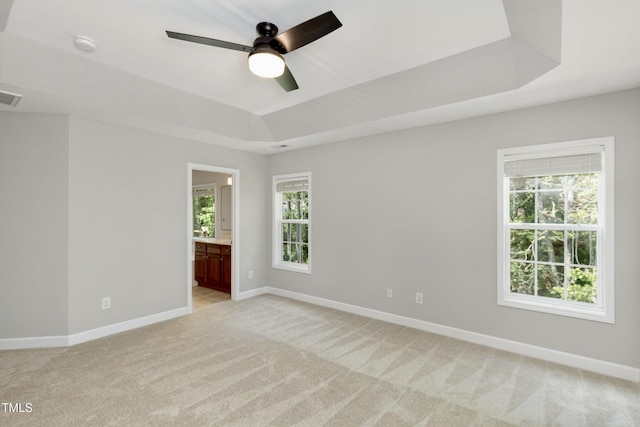 1304 Trailing Rose Ct, Wake Forest, NC 27587 - spare room featuring a ceiling fan, light colored carpet, a raised ceiling, and a smoke detector