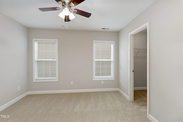 1304 Trailing Rose Ct, Wake Forest, NC 27587 - unfurnished bedroom with a spacious closet, light carpet, a closet, and ceiling fan