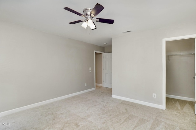 1304 Trailing Rose Ct, Wake Forest, NC 27587 - unfurnished bedroom featuring carpet flooring, a closet, ceiling fan, and a walk in closet
