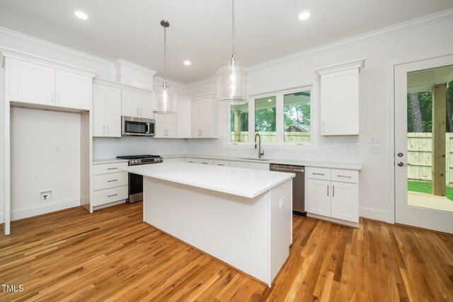 905 Deboy St, Raleigh, NC 27606 - kitchen featuring stainless steel appliances, light wood finished floors, white cabinets, backsplash, and recessed lighting