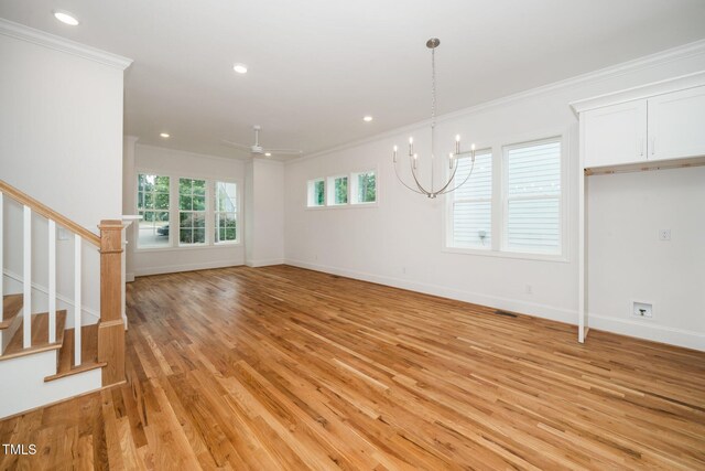 905 Deboy St, Raleigh, NC 27606 - unfurnished living room featuring ornamental molding, stairway, light wood-type flooring, recessed lighting, and a chandelier