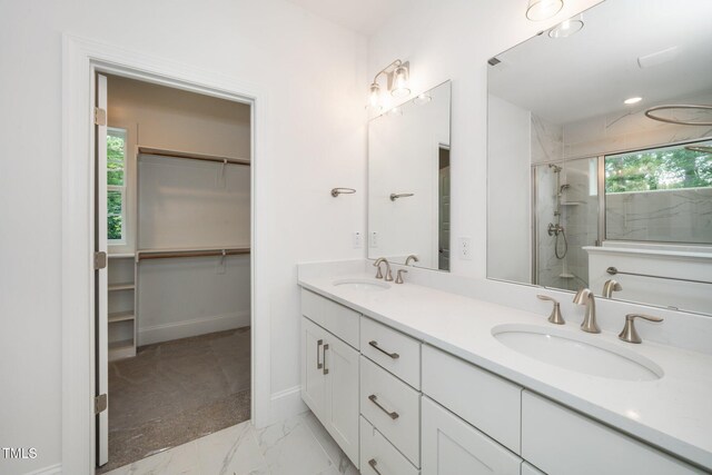 905 Deboy St, Raleigh, NC 27606 - full bath with double vanity, a tile shower, marble finish flooring, a walk in closet, and recessed lighting