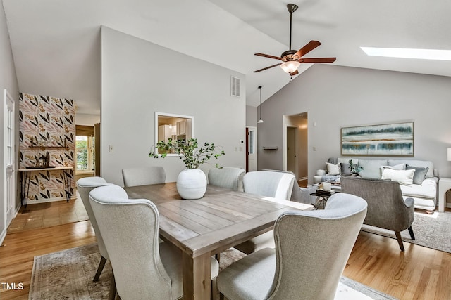 311 Westbrook Dr, Carrboro, NC 27510 - dining area featuring ceiling fan, light wood finished floors, high vaulted ceiling, and a skylight