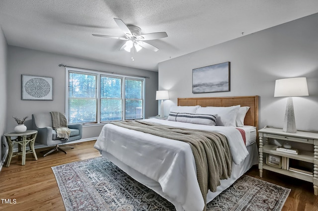 311 Westbrook Dr, Carrboro, NC 27510 - bedroom with wood finished floors, a textured ceiling, and ceiling fan
