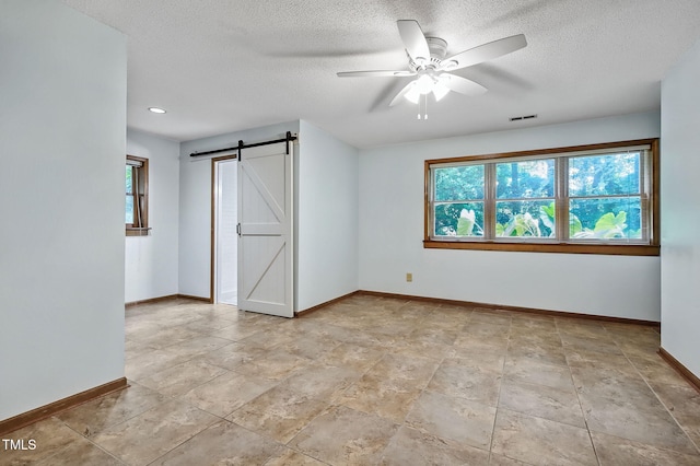 311 Westbrook Dr, Carrboro, NC 27510 - spare room featuring a barn door, a ceiling fan, a textured ceiling, and recessed lighting