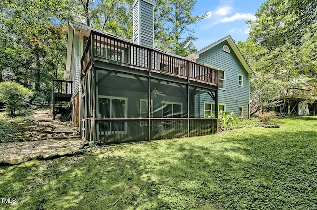 311 Westbrook Dr, Carrboro, NC 27510 - back of house with a lawn, a chimney, a balcony, and a sunroom