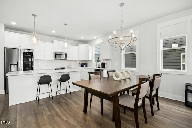 513 Basin Hill Dr, Wake Forest, NC 27587 - dining room with a chandelier, dark wood-style flooring, and recessed lighting