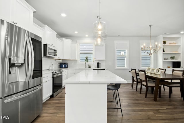 513 Basin Hill Dr, Wake Forest, NC 27587 - kitchen with stainless steel appliances, a chandelier, a breakfast bar area, dark wood finished floors, and recessed lighting