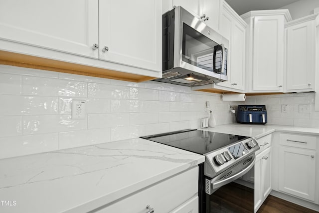 513 Basin Hill Dr, Wake Forest, NC 27587 - kitchen featuring appliances with stainless steel finishes, white cabinetry, decorative backsplash, and light stone countertops
