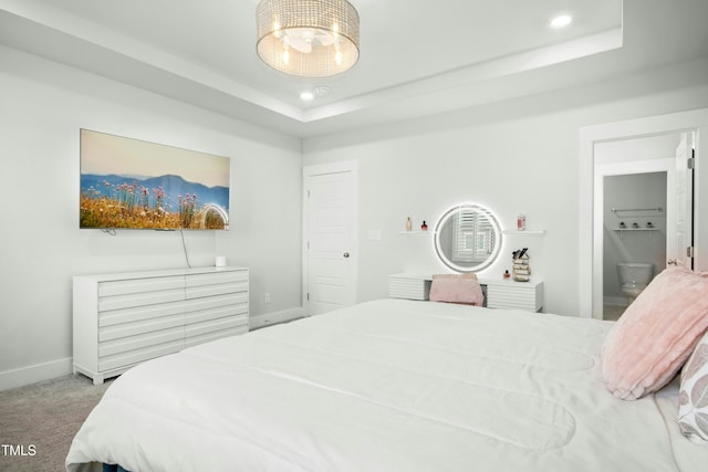 513 Basin Hill Dr, Wake Forest, NC 27587 - carpeted bedroom with a raised ceiling, recessed lighting, ensuite bath, and a chandelier