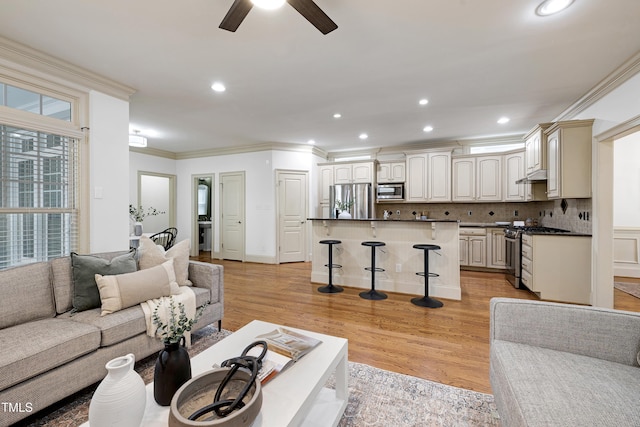 1217 Chalk Maple Dr, Cary, NC 27519 - living area featuring crown molding, a ceiling fan, light wood-style floors, and recessed lighting
