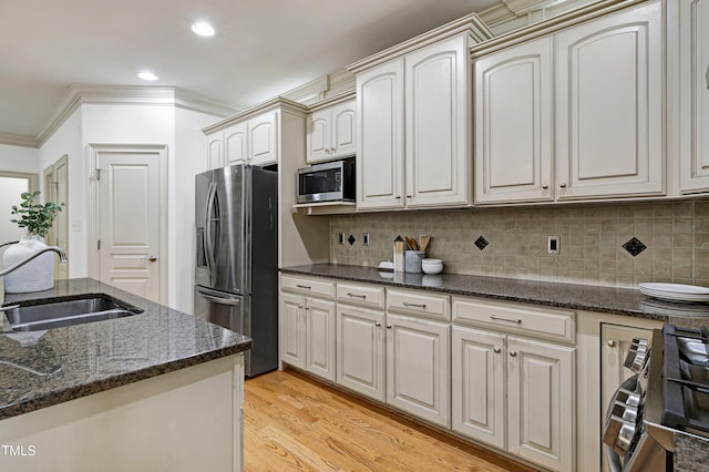 1217 Chalk Maple Dr, Cary, NC 27519 - kitchen with stainless steel appliances, light wood-type flooring, tasteful backsplash, recessed lighting, and dark stone countertops