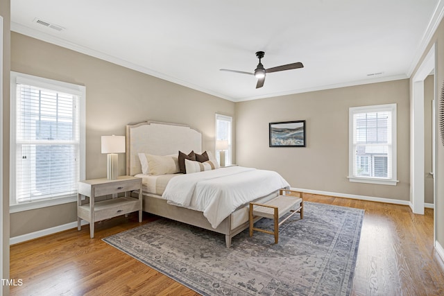 1217 Chalk Maple Dr, Cary, NC 27519 - bedroom featuring multiple windows, crown molding, wood finished floors, and a ceiling fan