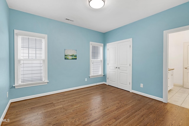1217 Chalk Maple Dr, Cary, NC 27519 - unfurnished bedroom featuring wood finished floors, a closet, and ensuite bathroom