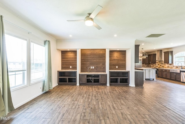 589 Atkinson Mill Rd, Selma, NC 27576 - unfurnished living room featuring wood finished floors, a ceiling fan, and ornamental molding