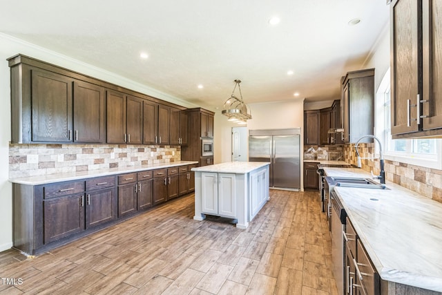 589 Atkinson Mill Rd, Selma, NC 27576 - kitchen featuring built in appliances, a center island, tasteful backsplash, dark brown cabinets, and recessed lighting