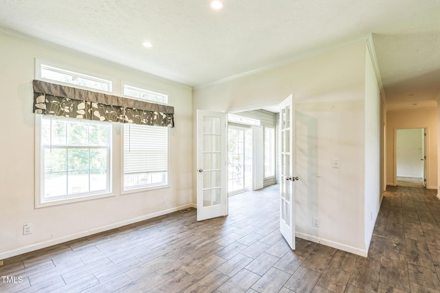 589 Atkinson Mill Rd, Selma, NC 27576 - empty room with french doors, crown molding, wood finished floors, healthy amount of natural light, and recessed lighting