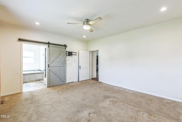 589 Atkinson Mill Rd, Selma, NC 27576 - unfurnished bedroom with a barn door, crown molding, carpet floors, ensuite bathroom, and recessed lighting