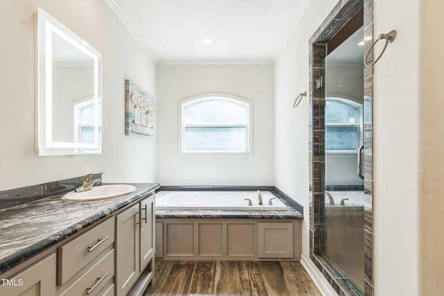 589 Atkinson Mill Rd, Selma, NC 27576 - bathroom featuring vanity, ornamental molding, a garden tub, a stall shower, and wood finished floors