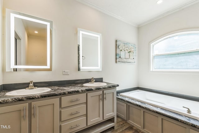 589 Atkinson Mill Rd, Selma, NC 27576 - full bath featuring wood finished floors, double vanity, ornamental molding, and a garden tub