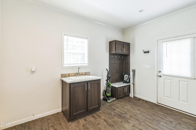 589 Atkinson Mill Rd, Selma, NC 27576 - laundry area featuring dark wood-type flooring and ornamental molding