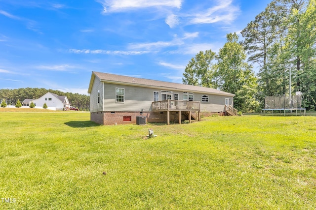 589 Atkinson Mill Rd, Selma, NC 27576 - rear view of property with a trampoline, a deck, crawl space, stairway, and a lawn