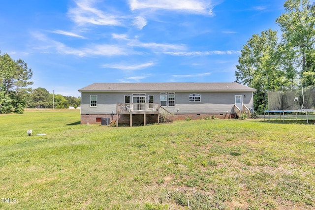 589 Atkinson Mill Rd, Selma, NC 27576 - rear view of property featuring crawl space, a trampoline, a wooden deck, a yard, and stairway