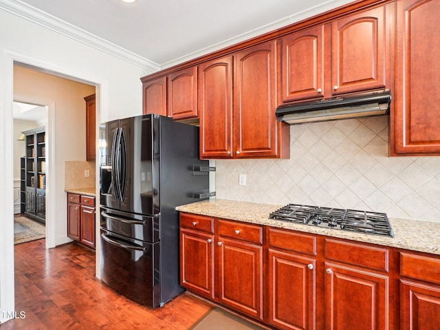 214 Ashdown Forest Ln, Cary, NC 27519 - kitchen featuring black refrigerator with ice dispenser, gas cooktop, under cabinet range hood, tasteful backsplash, and light stone countertops