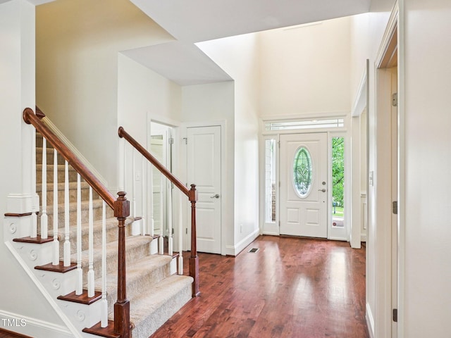 214 Ashdown Forest Ln, Cary, NC 27519 - entryway featuring dark wood-style flooring and stairway