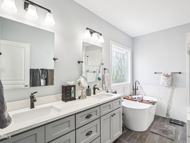 214 Ashdown Forest Ln, Cary, NC 27519 - full bath with walk in shower, double vanity, a freestanding tub, wood finish floors, and wainscoting