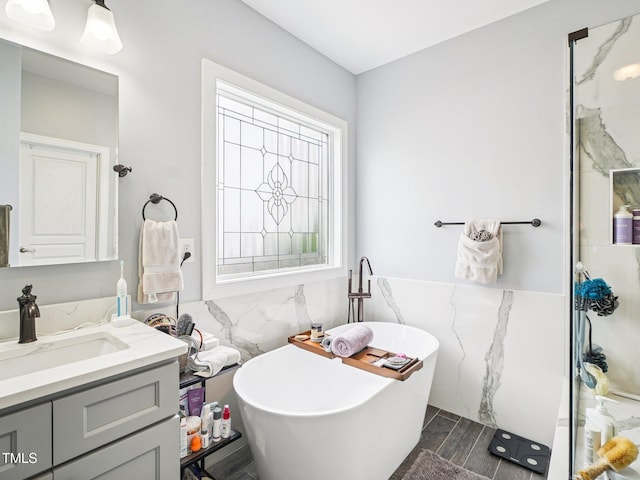 214 Ashdown Forest Ln, Cary, NC 27519 - bathroom featuring tile walls, vanity, a freestanding bath, and a wainscoted wall