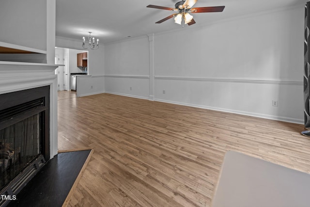 9908 Jerome Ct, Raleigh, NC 27617 - unfurnished living room featuring a ceiling fan, a chandelier, light wood-style floors, a fireplace, and ornamental molding