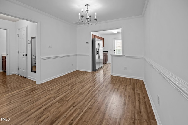 9908 Jerome Ct, Raleigh, NC 27617 - unfurnished dining area featuring wood finished floors, a chandelier, and crown molding