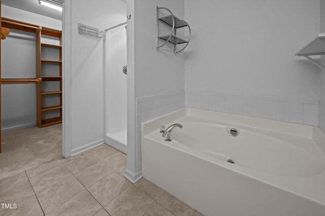 9908 Jerome Ct, Raleigh, NC 27617 - full bath with a spacious closet, a garden tub, tile patterned floors, and a shower