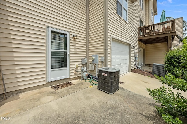 9908 Jerome Ct, Raleigh, NC 27617 - view of patio featuring a garage and driveway