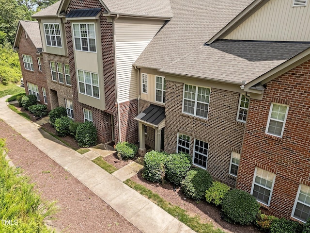 9908 Jerome Ct, Raleigh, NC 27617 - view of side of property with a shingled roof and brick siding