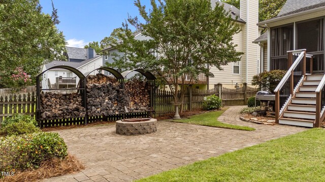 1033 Mills St, Raleigh, NC 27608 - view of patio with an outdoor fire pit, a sunroom, and stairs