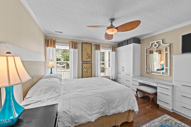 1033 Mills St, Raleigh, NC 27608 - bedroom with crown molding, a textured ceiling, dark wood-type flooring, a ceiling fan, and a desk