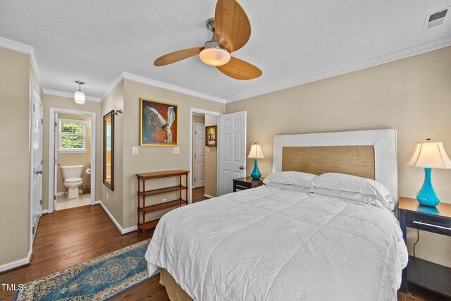 1033 Mills St, Raleigh, NC 27608 - bedroom featuring crown molding, wood finished floors, a textured ceiling, ensuite bath, and ceiling fan