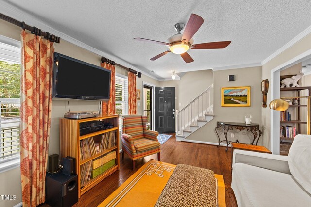 1033 Mills St, Raleigh, NC 27608 - living area with ceiling fan, wood finished floors, a textured ceiling, stairway, and crown molding