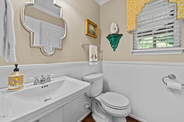 1033 Mills St, Raleigh, NC 27608 - bathroom featuring a wainscoted wall, ornamental molding, and wood finished floors