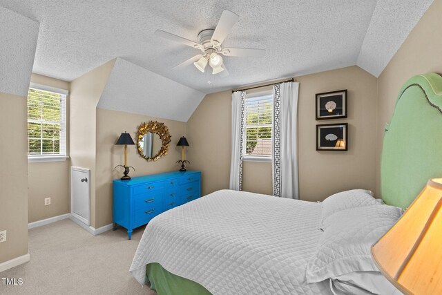 1033 Mills St, Raleigh, NC 27608 - bedroom with lofted ceiling, light carpet, a textured ceiling, and a ceiling fan