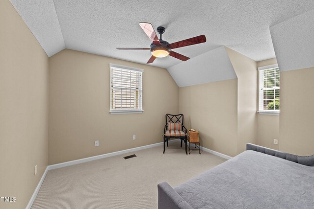 1033 Mills St, Raleigh, NC 27608 - carpeted bedroom featuring vaulted ceiling, multiple windows, and a ceiling fan