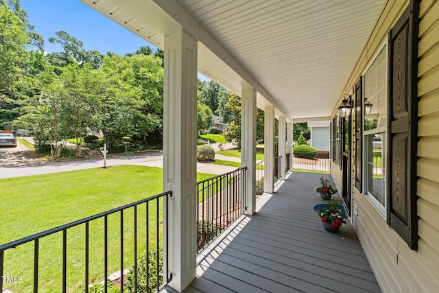 1033 Mills St, Raleigh, NC 27608 - wooden porch featuring a lawn