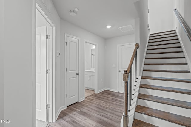2539 Kasota Ln, Raleigh, NC 27610 - stairs featuring wood finished floors and recessed lighting