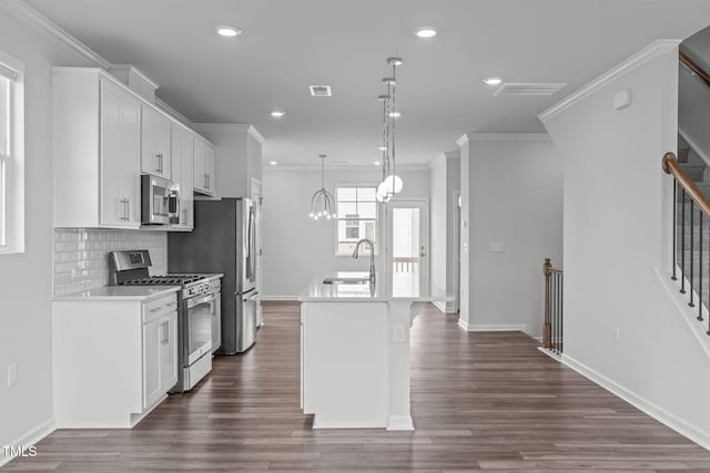 2539 Kasota Ln, Raleigh, NC 27610 - kitchen featuring stainless steel appliances, a center island with sink, recessed lighting, dark wood-style flooring, and crown molding