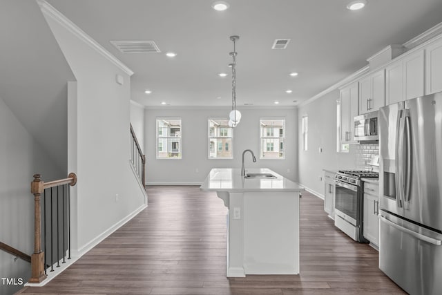 2539 Kasota Ln, Raleigh, NC 27610 - kitchen featuring stainless steel appliances, crown molding, a kitchen island with sink, recessed lighting, and plenty of natural light