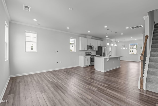 2539 Kasota Ln, Raleigh, NC 27610 - unfurnished living room featuring stairway, ornamental molding, dark wood-style flooring, and recessed lighting
