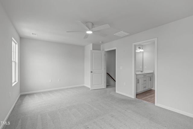 2539 Kasota Ln, Raleigh, NC 27610 - unfurnished bedroom with carpet flooring, connected bathroom, a ceiling fan, and multiple windows