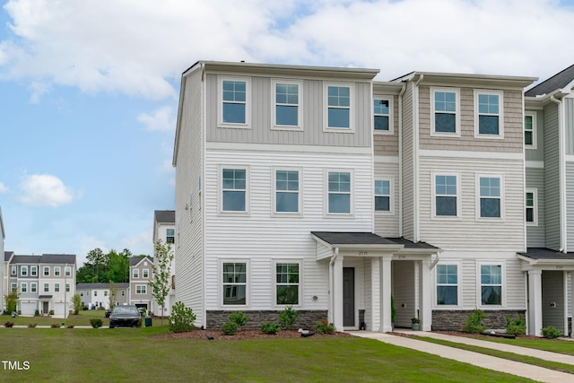 2539 Kasota Ln, Raleigh, NC 27610 - townhome / multi-family property with stone siding and a front yard
